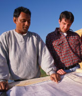 two men consulting plans